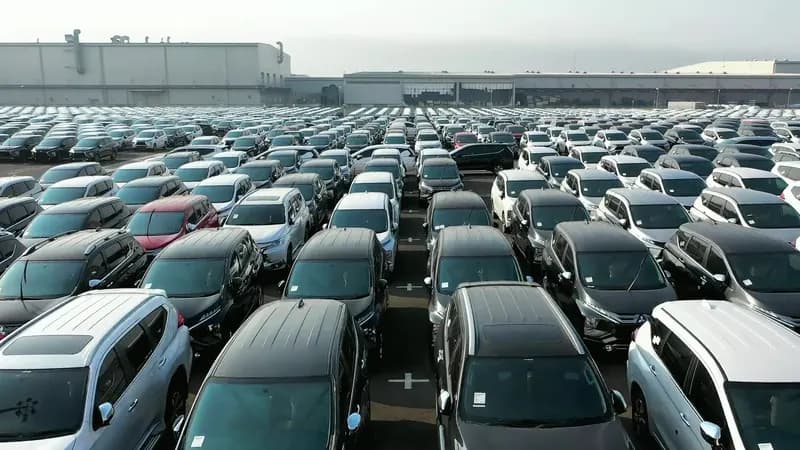 Rows of new SUVs and cars parked on a dealer vehicle lot
